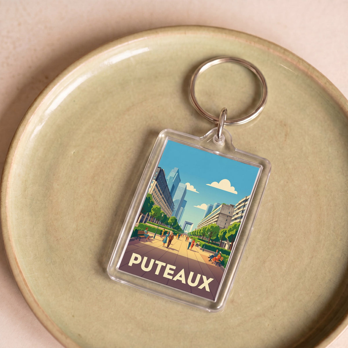 Porte-clés souvenir de la ville de Puteaux avec une illustration stylisée de son architecture moderne.