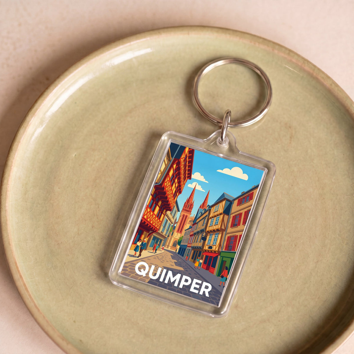 Porte-clés souvenir de la ville de Quimper avec une illustration stylisée.