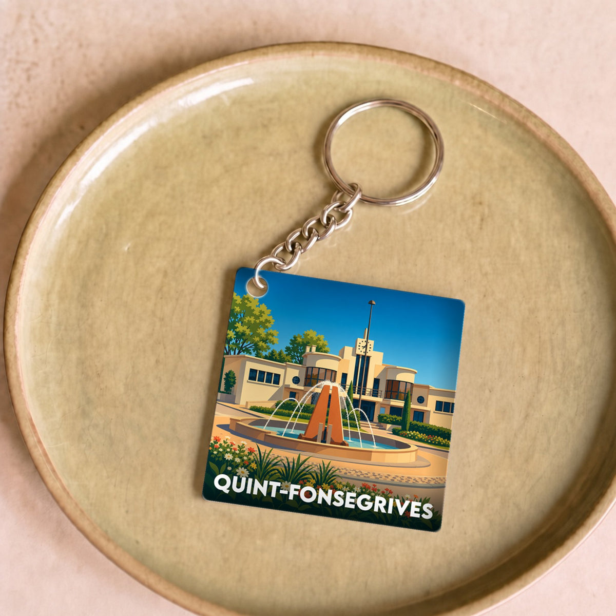 Porte-clés souvenir de la ville de Quint-Fonsegrives avec une illustration stylisée.