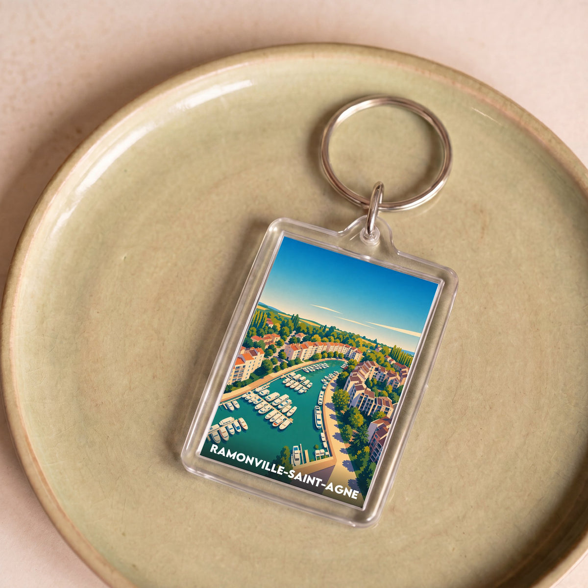 Porte-clés souvenir de la ville de Ramonville-Saint-Agne avec une illustration stylisée.