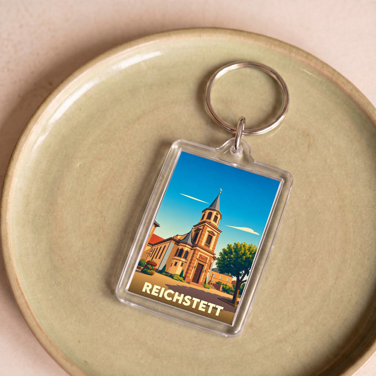 Porte-clés souvenir de la ville de Reichstett avec une illustration stylisée de son église.