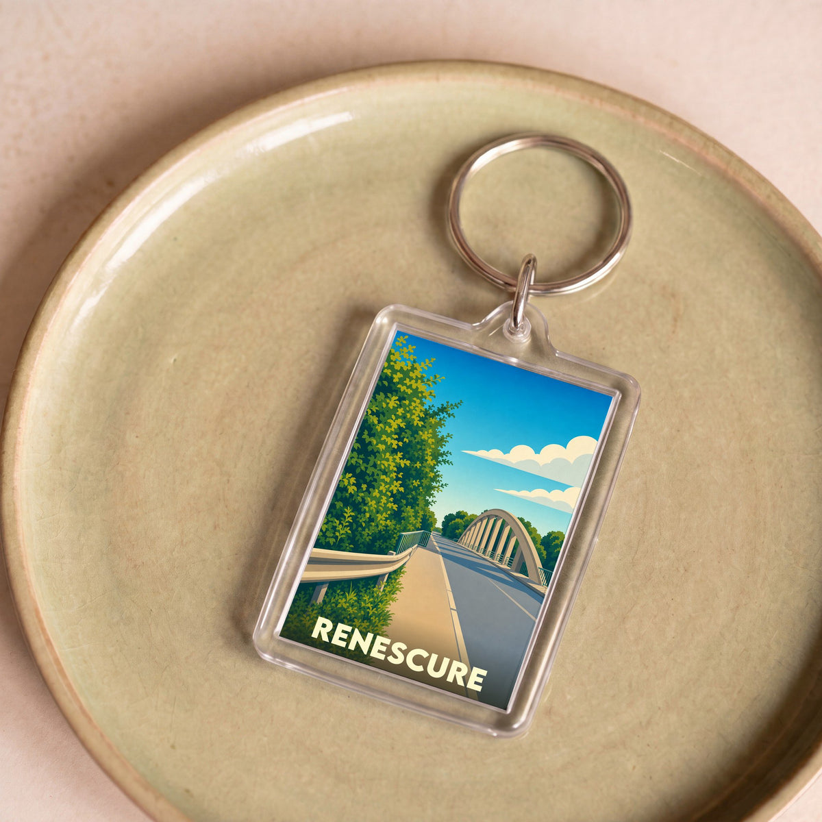 Porte-clés souvenir de la ville de Renescure avec une illustration stylisée d'un pont routier.