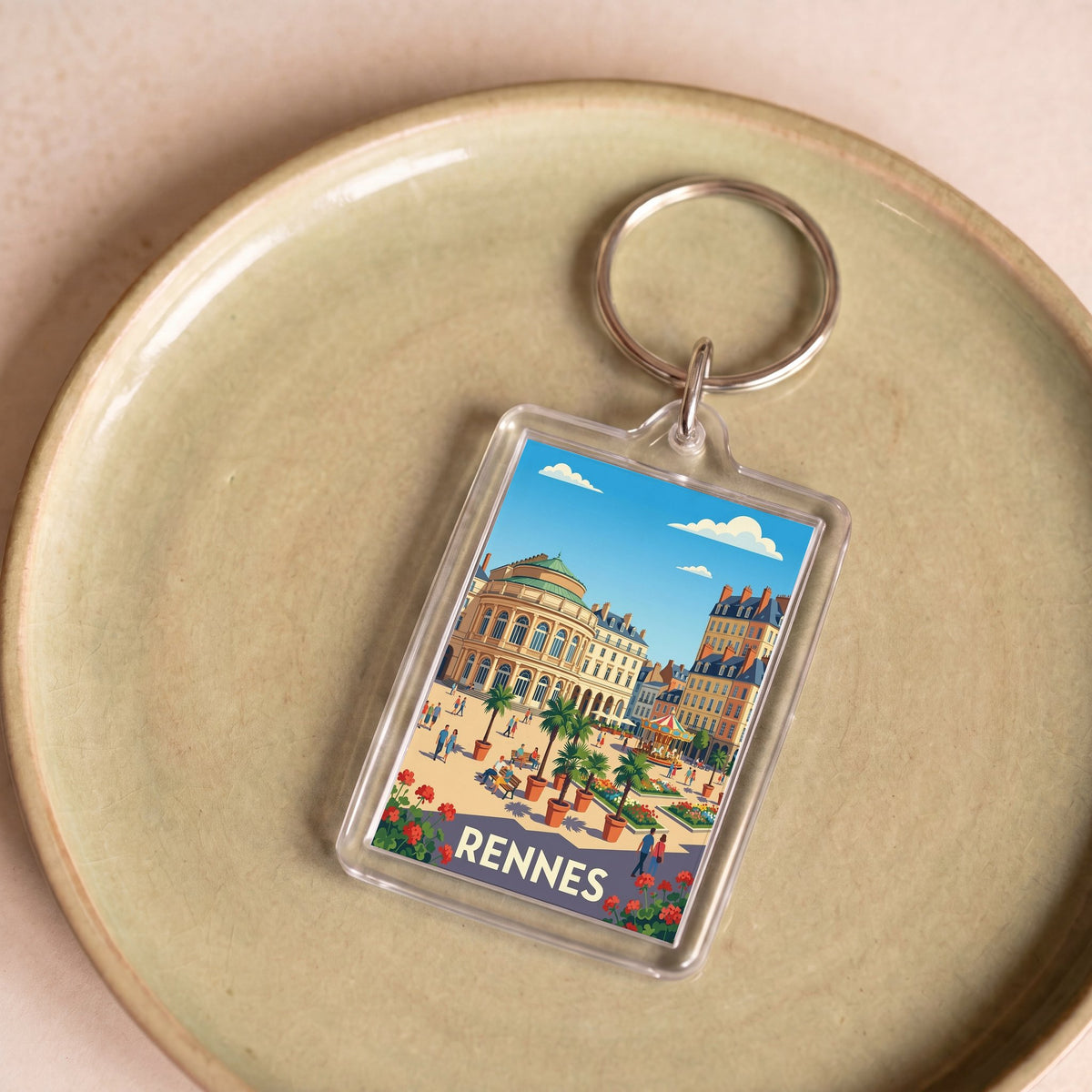Porte-clés souvenir de la ville de Rennes avec une illustration stylisée et colorée.