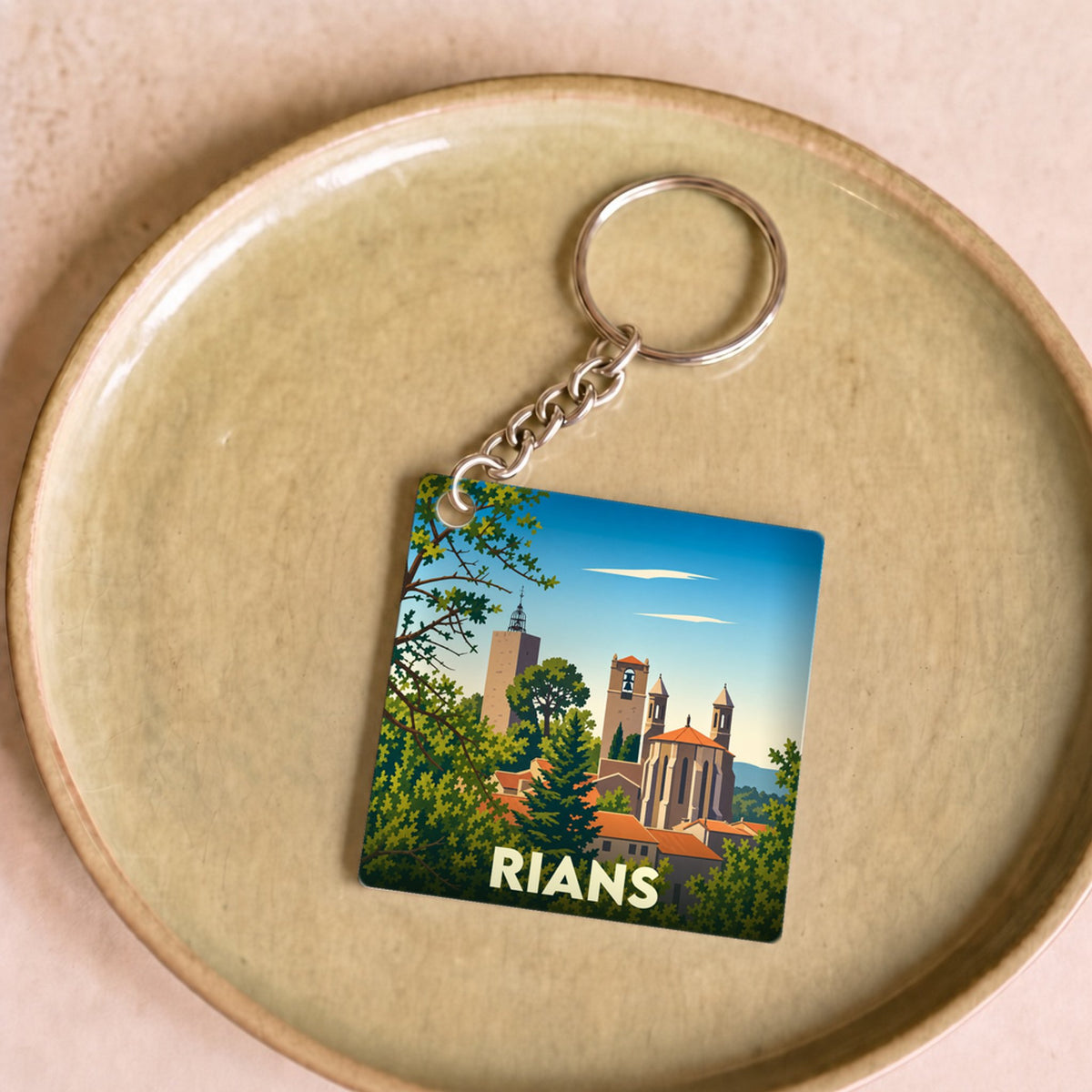 Porte-clés souvenir de la ville de Rians avec une illustration stylisée de son patrimoine.