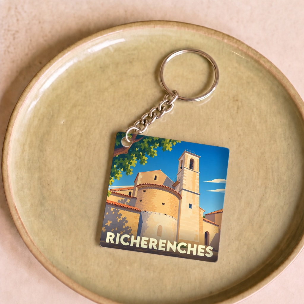 Porte-clés souvenir de la ville de Richerenches avec une illustration stylisée de son église et de son clocher.