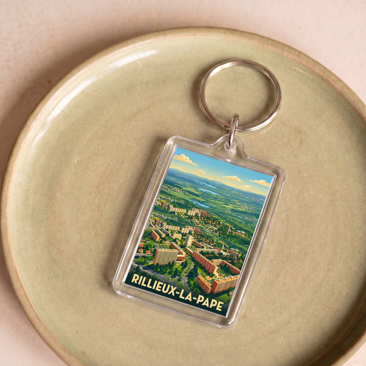 Porte-clés souvenir de la ville de Rillieux-la-Pape avec une illustration stylisée.