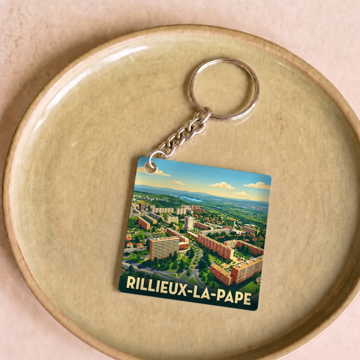 Porte-clés souvenir de la ville de Rillieux-la-Pape avec une illustration stylisée.