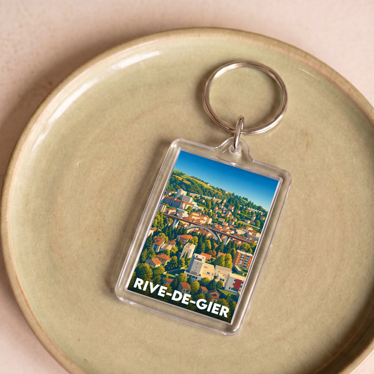 Porte-clés souvenir de la ville de Rive-de-Gier avec une illustration stylisée.