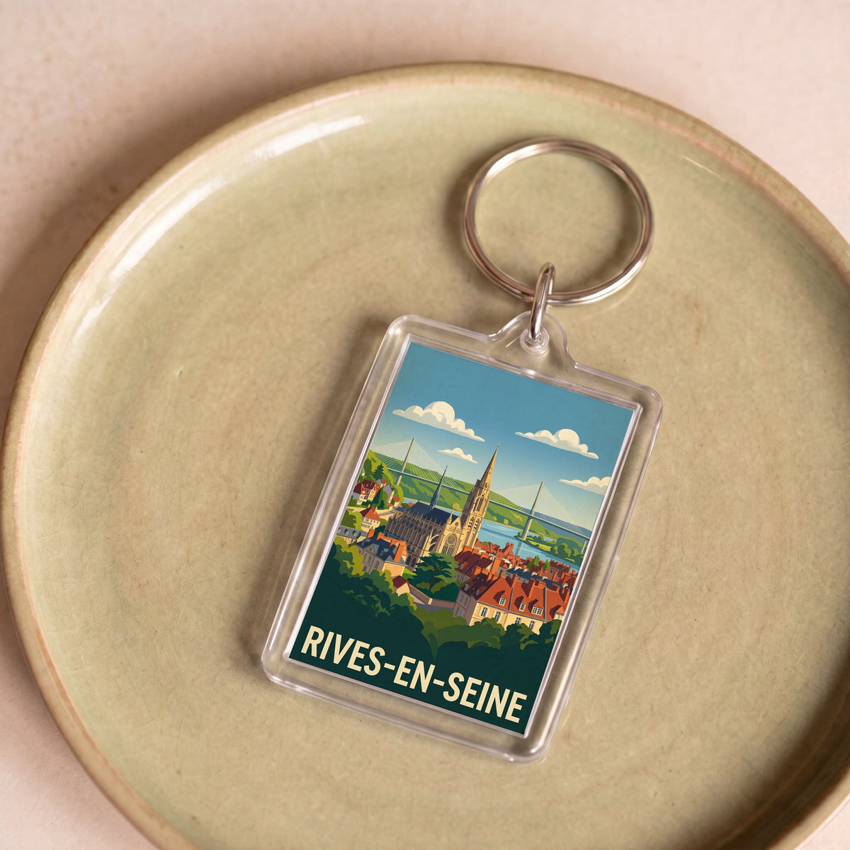 Porte-clés souvenir de la ville de Rives-en-Seine avec une illustration stylisée.