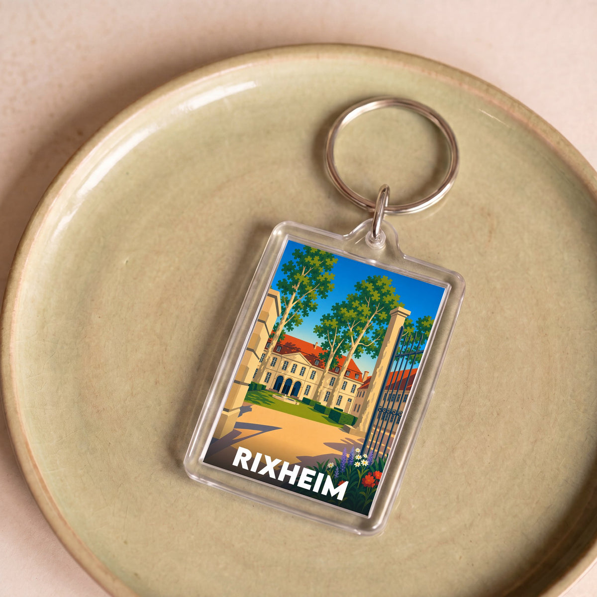 Porte-clés souvenir de la ville de Rixheim avec une illustration stylisée.