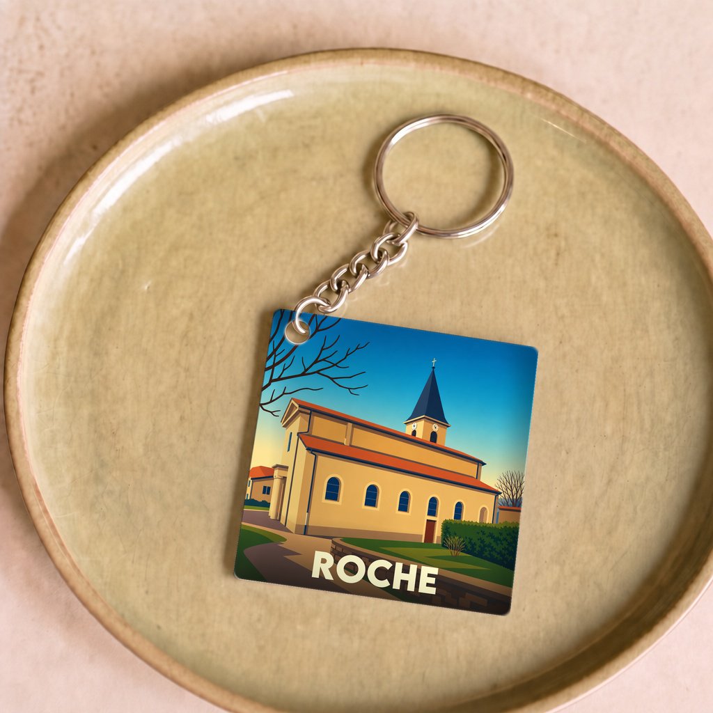 Porte-clés souvenir de la ville de Roche avec une illustration stylisée de son église.