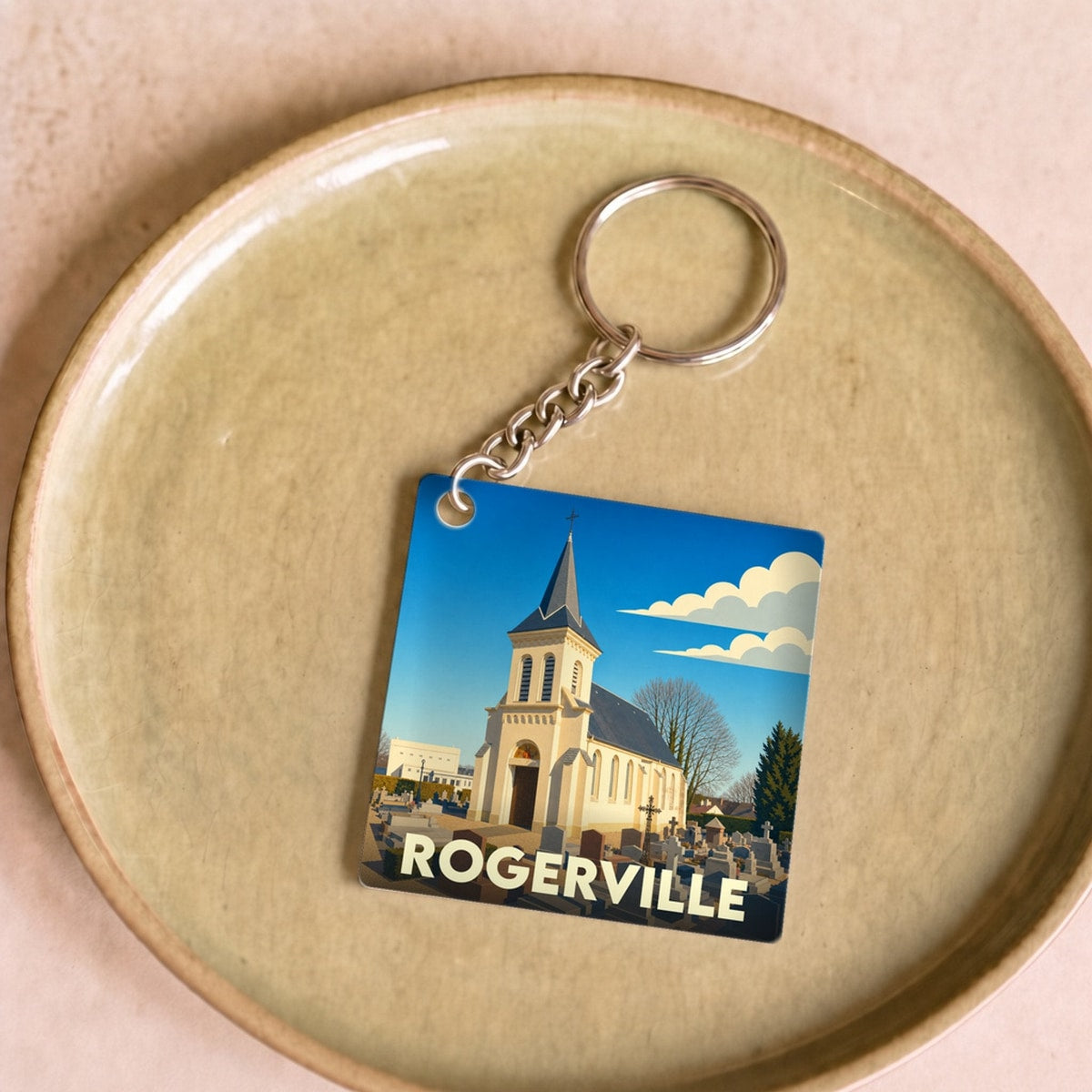 Porte-clés souvenir de la ville de Rogerville avec une illustration stylisée de son église.