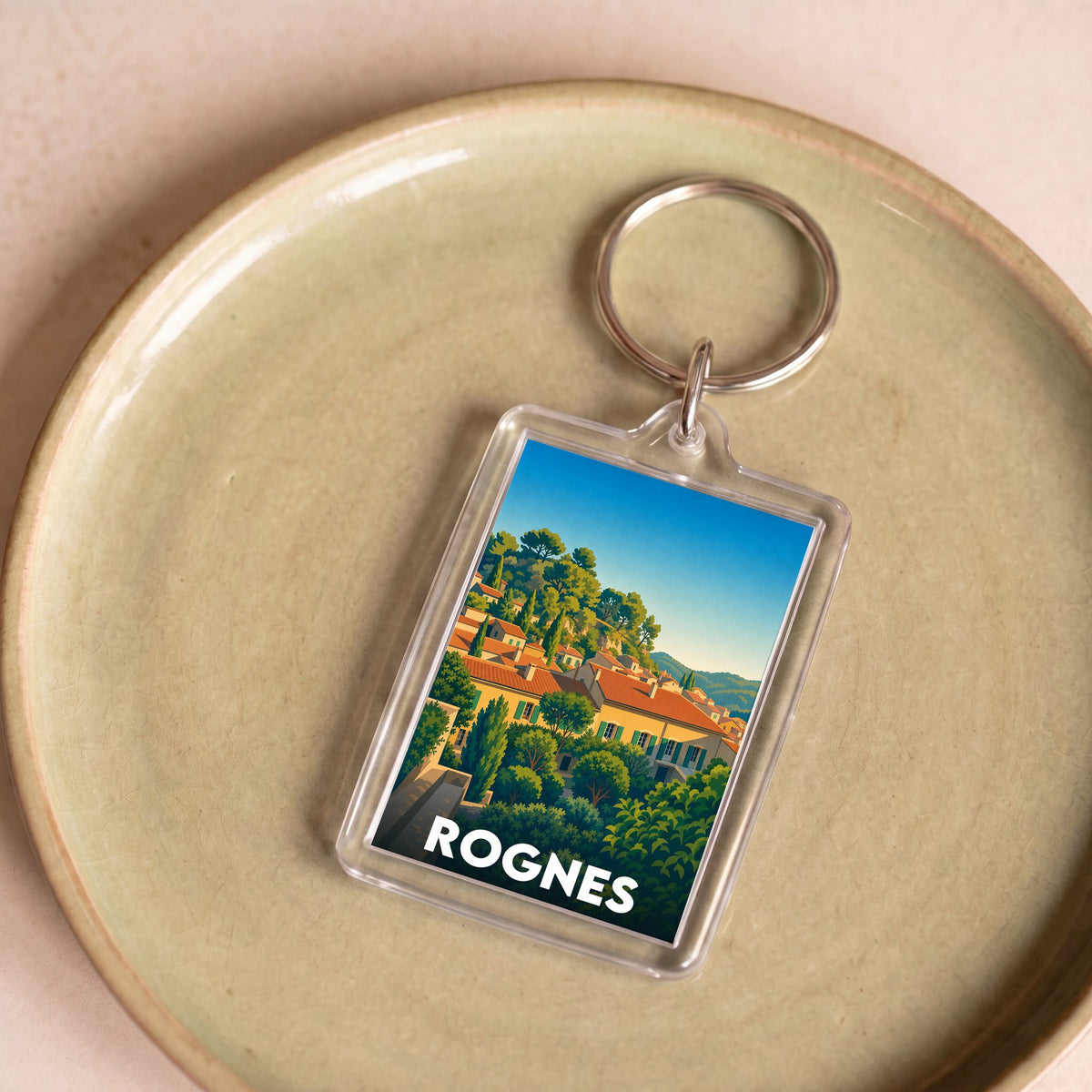 Porte-clés souvenir de la ville de Rognes avec une illustration stylisée.
