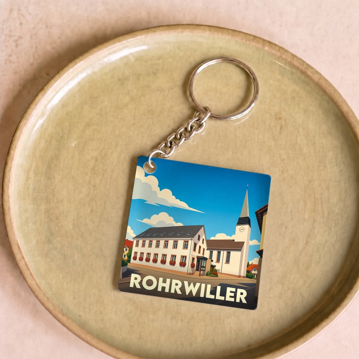 Porte-clés souvenir de la ville de Rohrwiller avec une illustration stylisée.