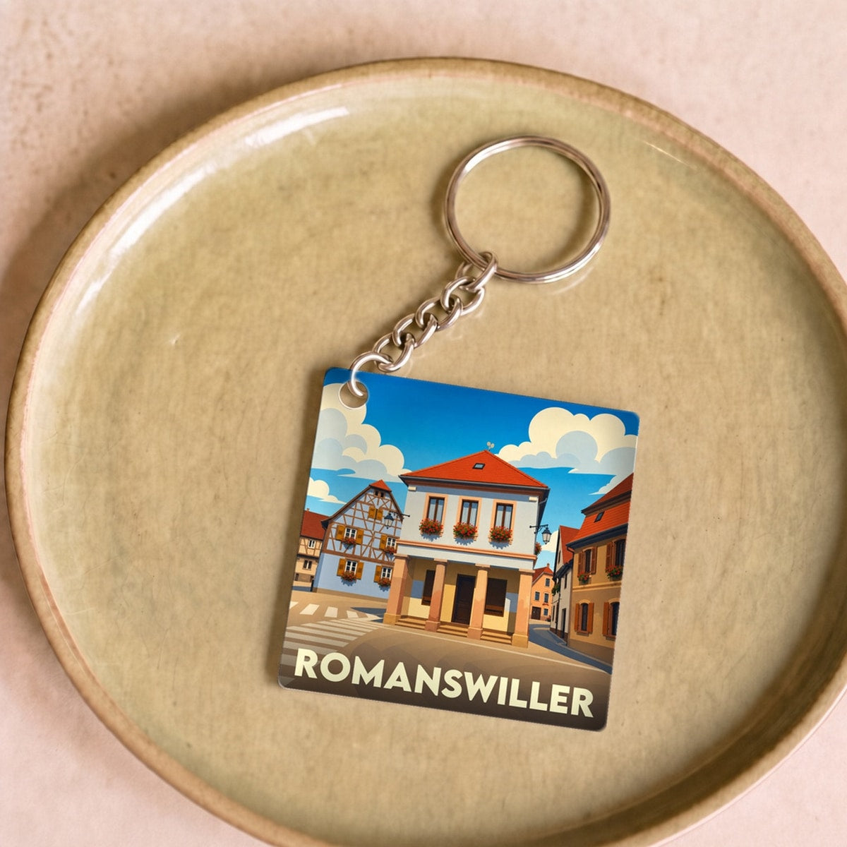 Porte-clés souvenir de la ville de Romanswiller avec une illustration stylisée.