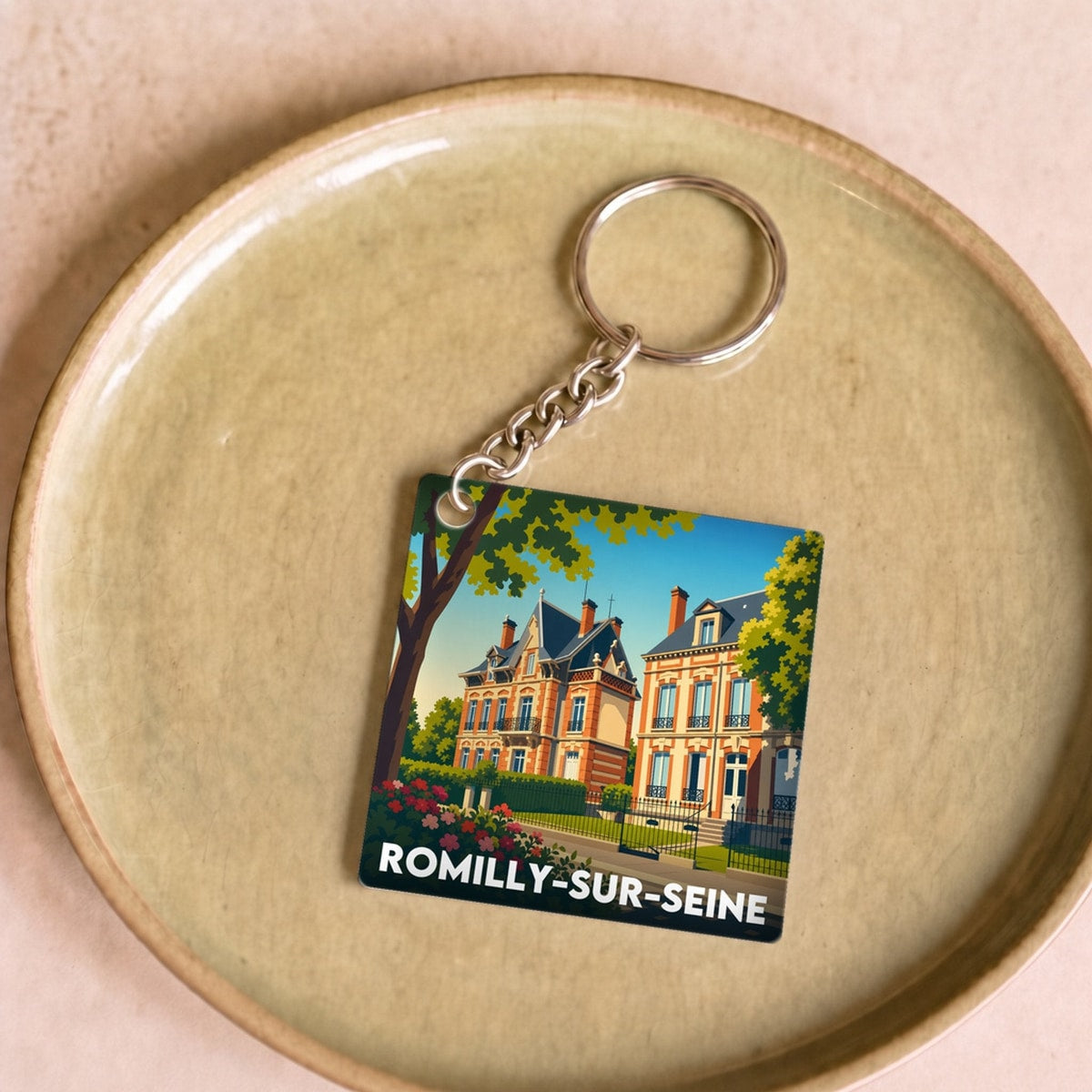 Porte-clés souvenir de la ville de Romilly-sur-Seine avec une illustration stylisée.
