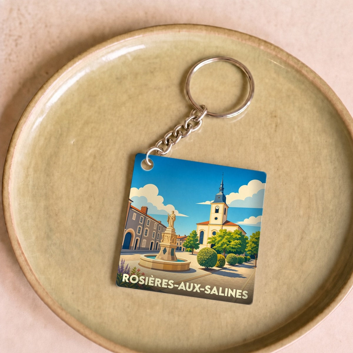 Porte-clés souvenir de la ville de Rosières-aux-Salines avec une illustration stylisée.