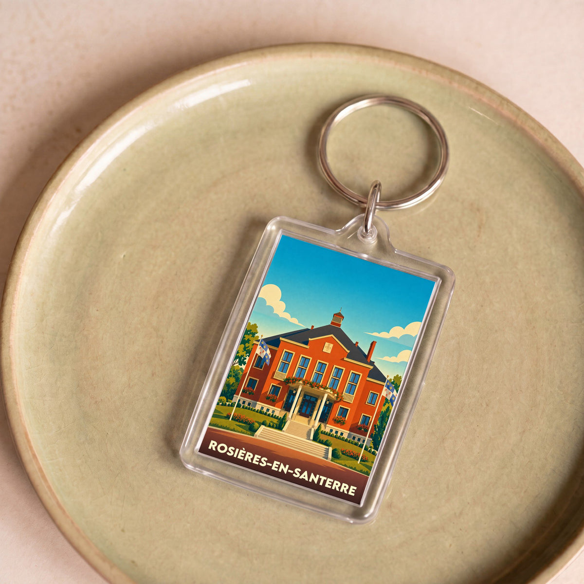 Porte-clés souvenir de la ville de Rosières-en-Santerre avec une illustration stylisée de son hôtel de ville.