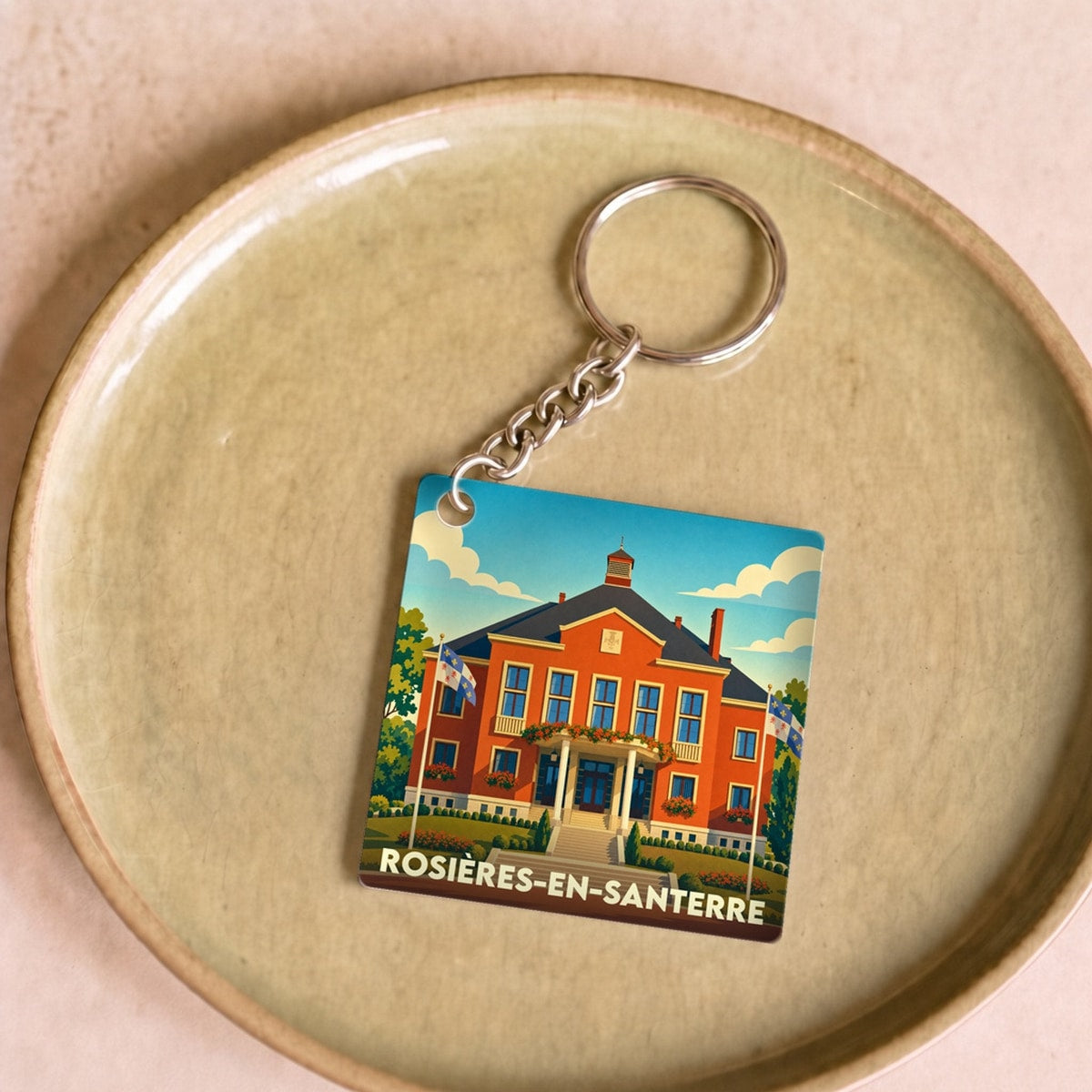 Porte-clés souvenir de la ville de Rosières-en-Santerre avec une illustration stylisée de son hôtel de ville.