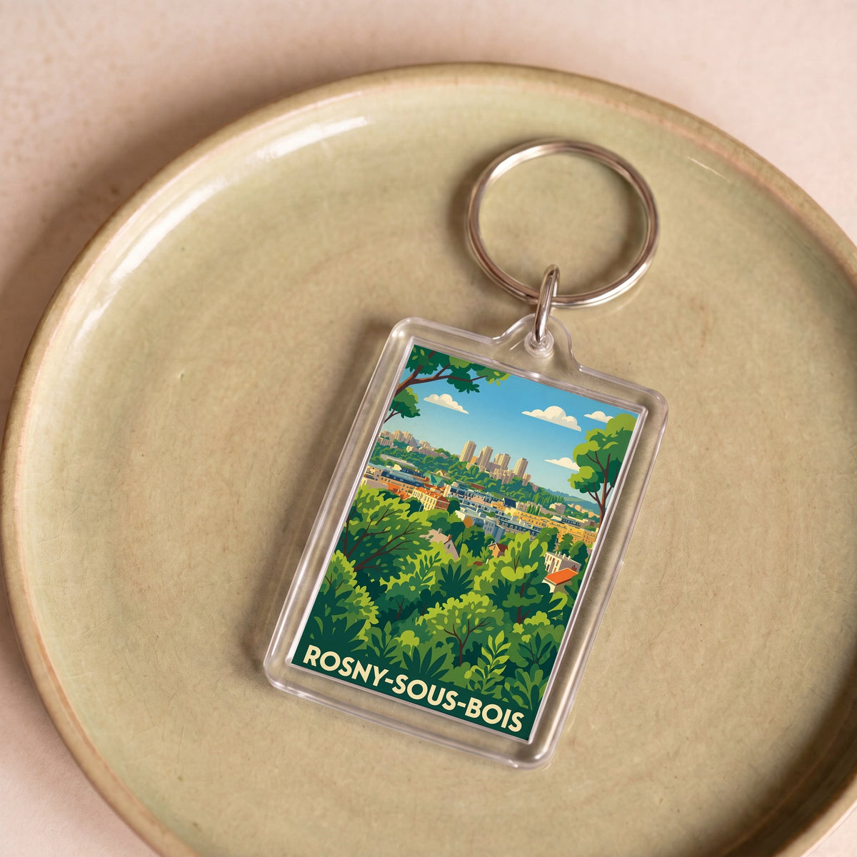 Porte-clés souvenir de la ville de Rosny-sous-Bois avec une illustration panoramique stylisée.