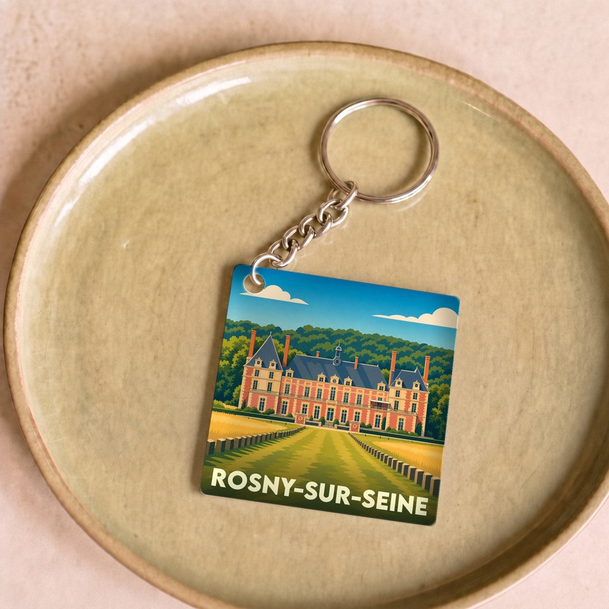 Porte-clés souvenir de la ville de Rosny-sur-Seine avec une illustration stylisée du château.
