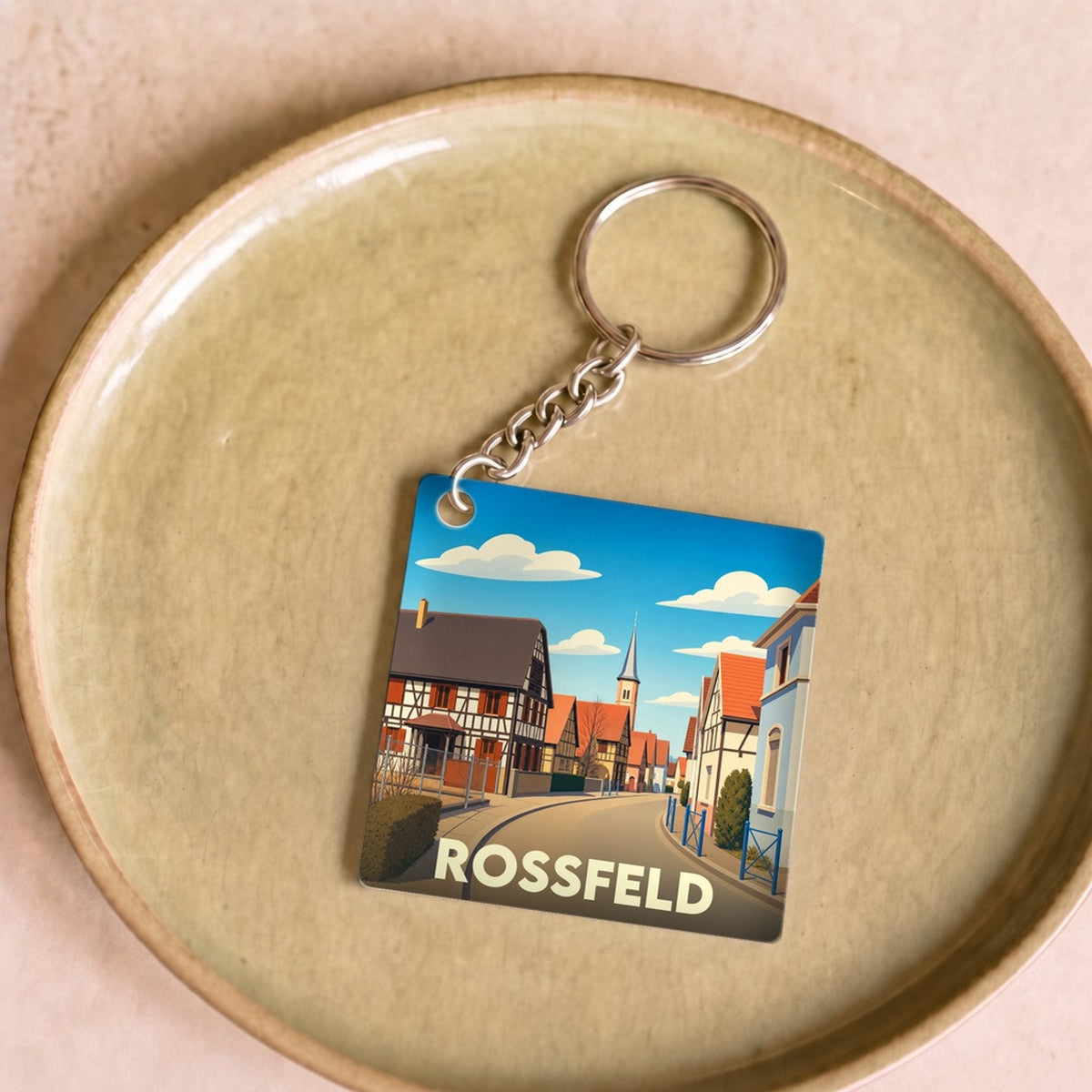 Porte-clés souvenir de la ville de Rossfeld avec une illustration stylisée.