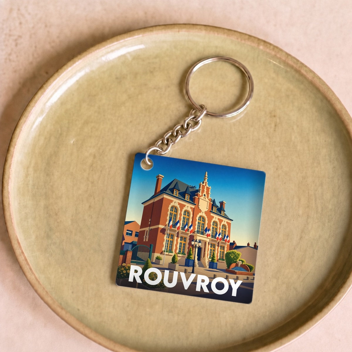 Porte-clés souvenir de la ville de Rouvroy orné d'une illustration stylisée de son hôtel de ville.