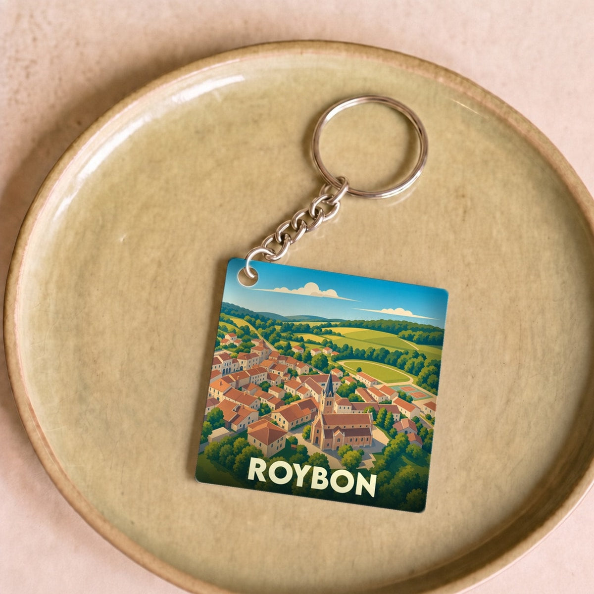 Porte-clés souvenir de la ville de Roybon avec une illustration stylisée.