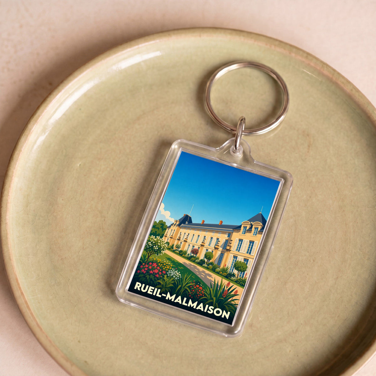 Porte-clés souvenir de la ville de Rueil-Malmaison avec une illustration stylisée de son château.