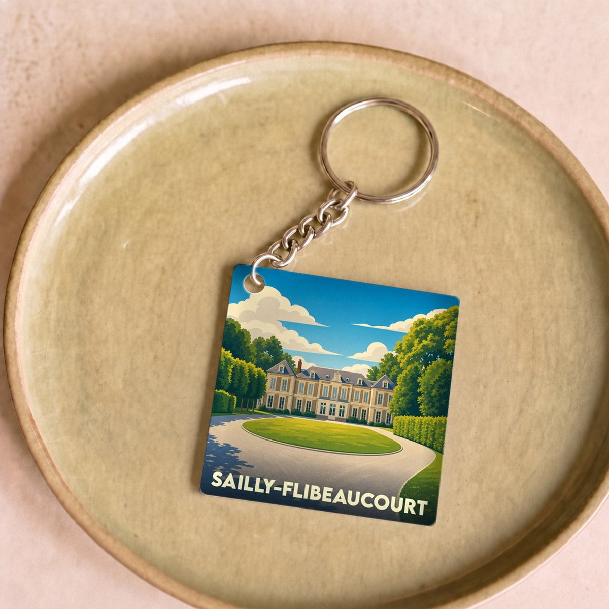 Porte-clés souvenir de la ville de Sailly-Flibeaucourt avec une illustration stylisée.