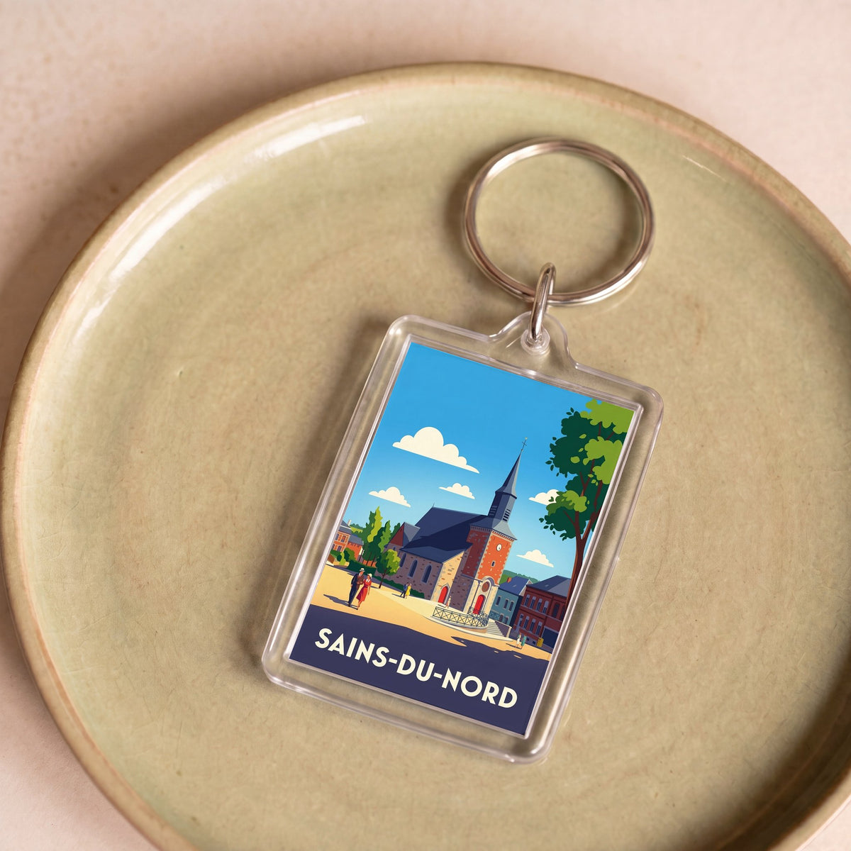 Porte-clés souvenir de la ville de Sains-du-Nord avec une illustration stylisée.