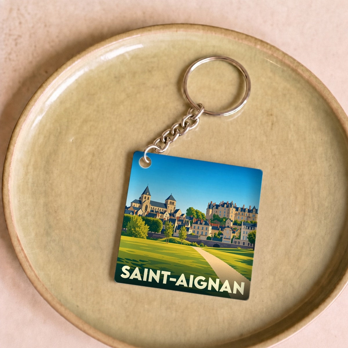Porte-clés souvenir de la ville de Saint-Aignan avec une illustration stylisée.