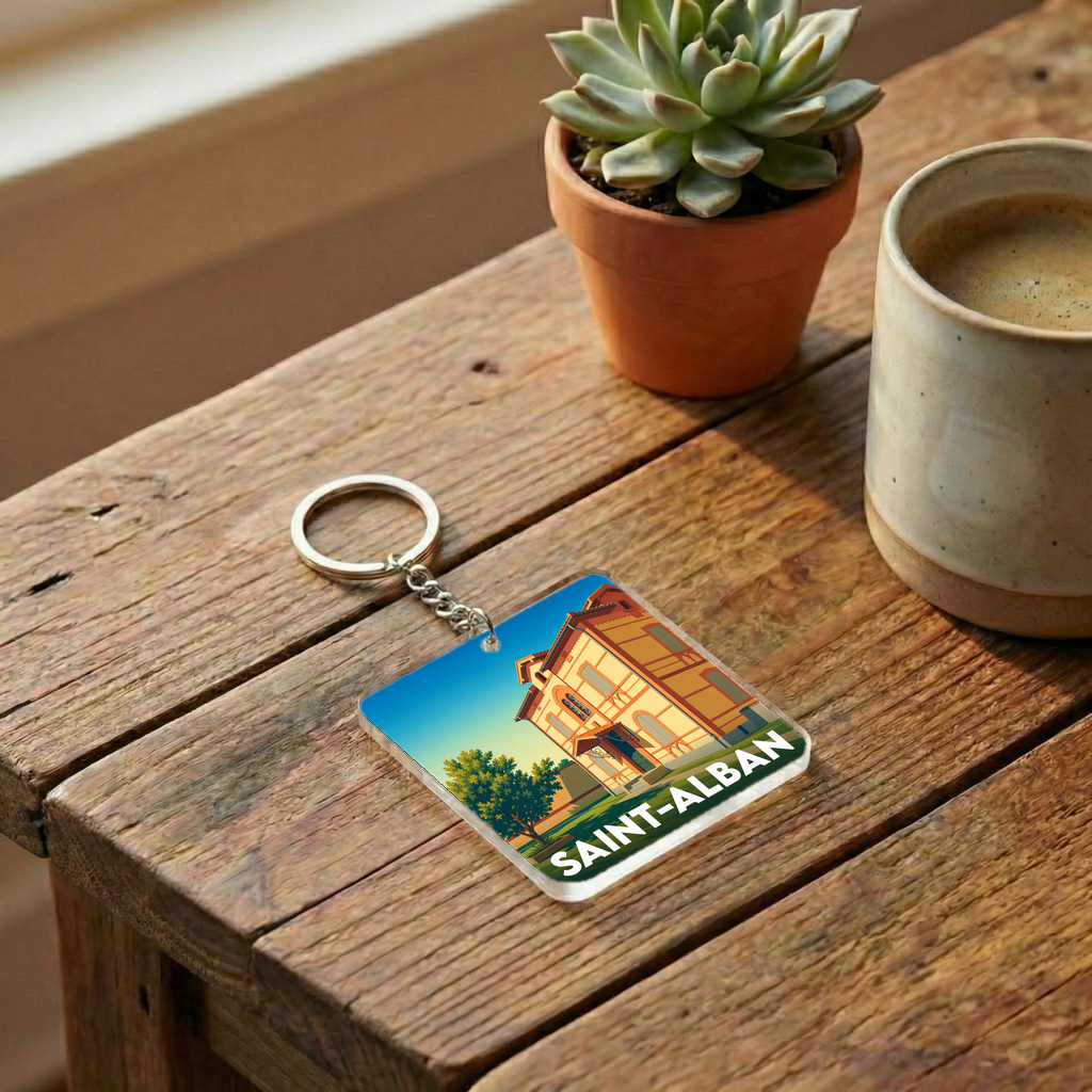 Porte-clés souvenir de la ville de Saint-Alban avec une illustration stylisée d'un bâtiment historique.