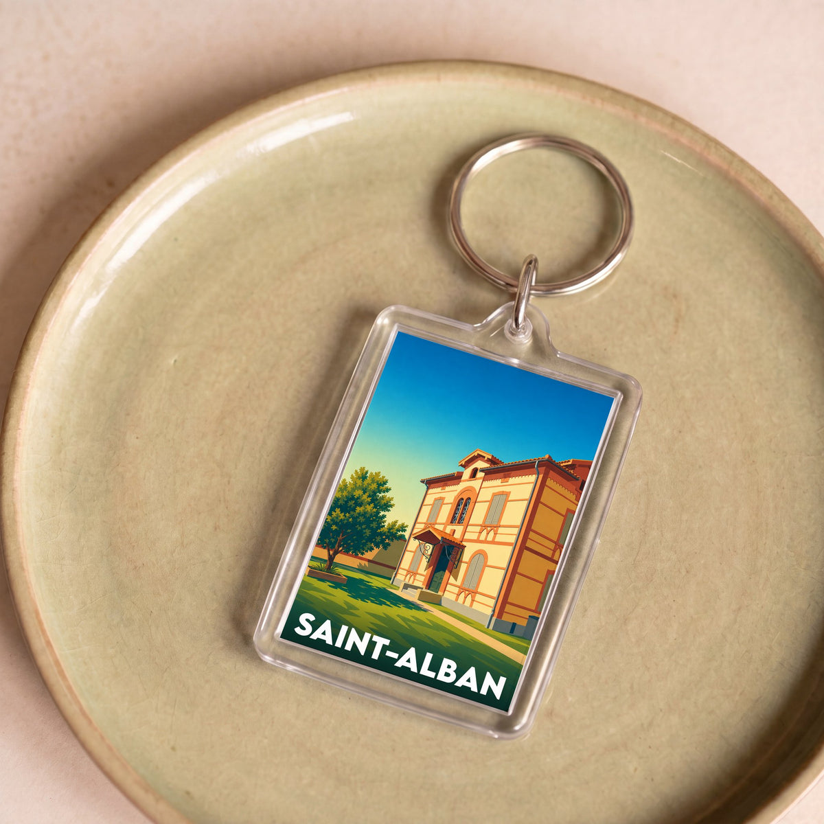 Porte-clés souvenir de la ville de Saint-Alban avec une illustration stylisée d'un bâtiment historique.