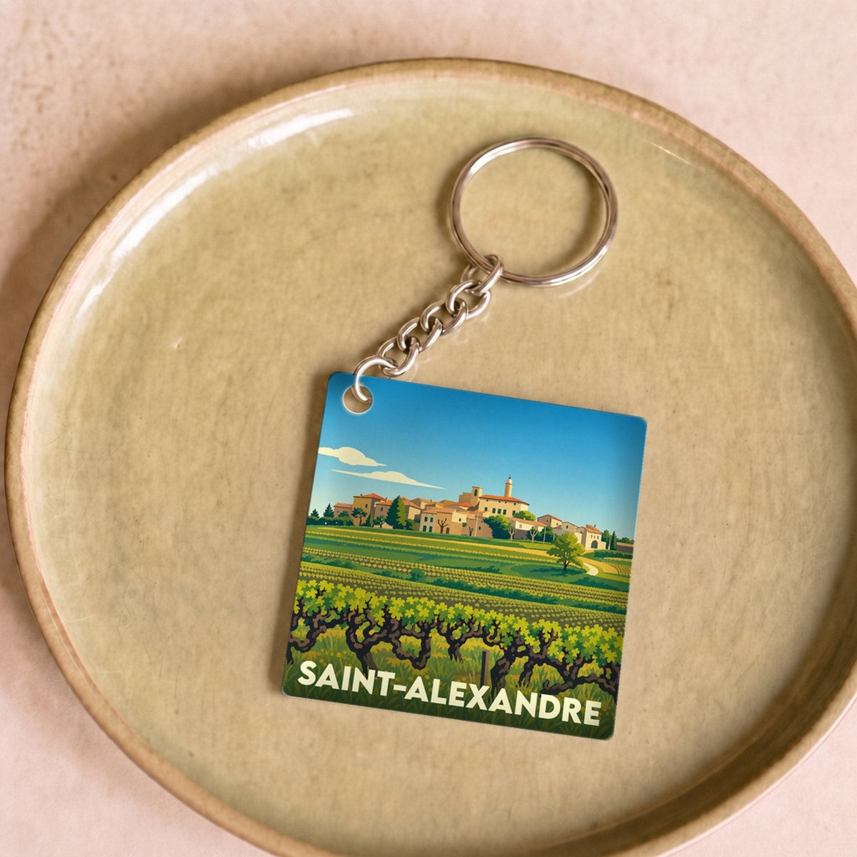 Porte-clés souvenir de la ville de Saint-Alexandre avec une illustration stylisée de vignes.
