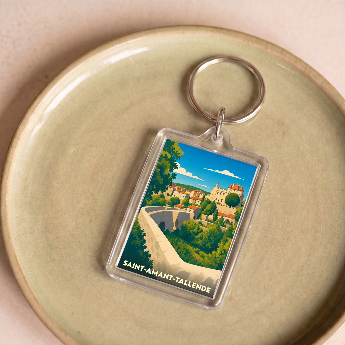 Porte-clés souvenir de la ville de Saint-Amant-Tallende avec une illustration stylisée.