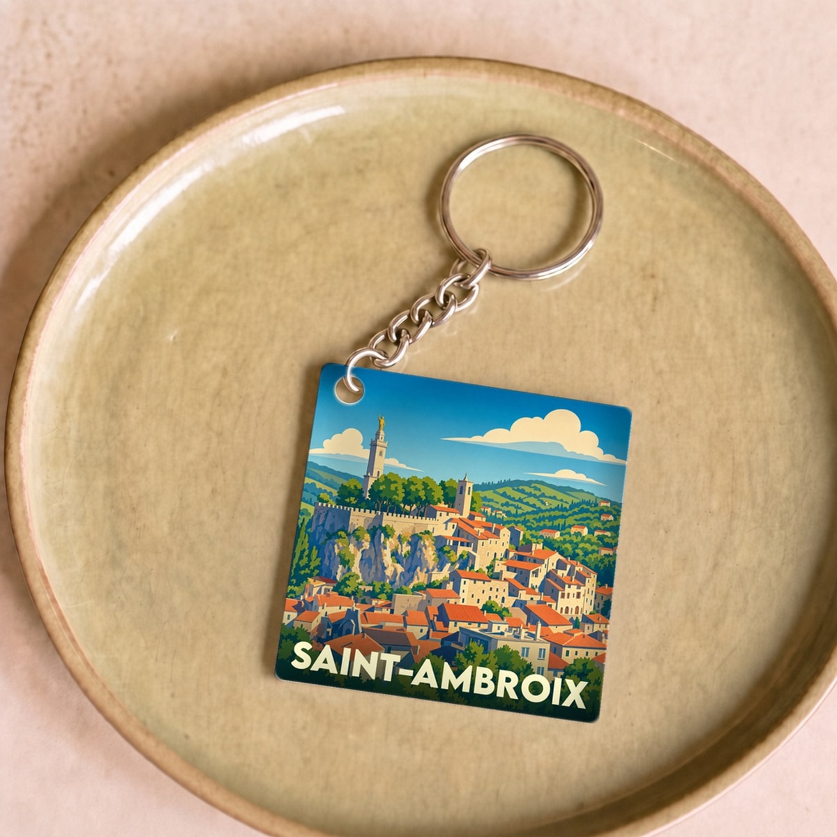 Porte-clés souvenir de la ville de Saint-Ambroix avec une illustration stylisée.