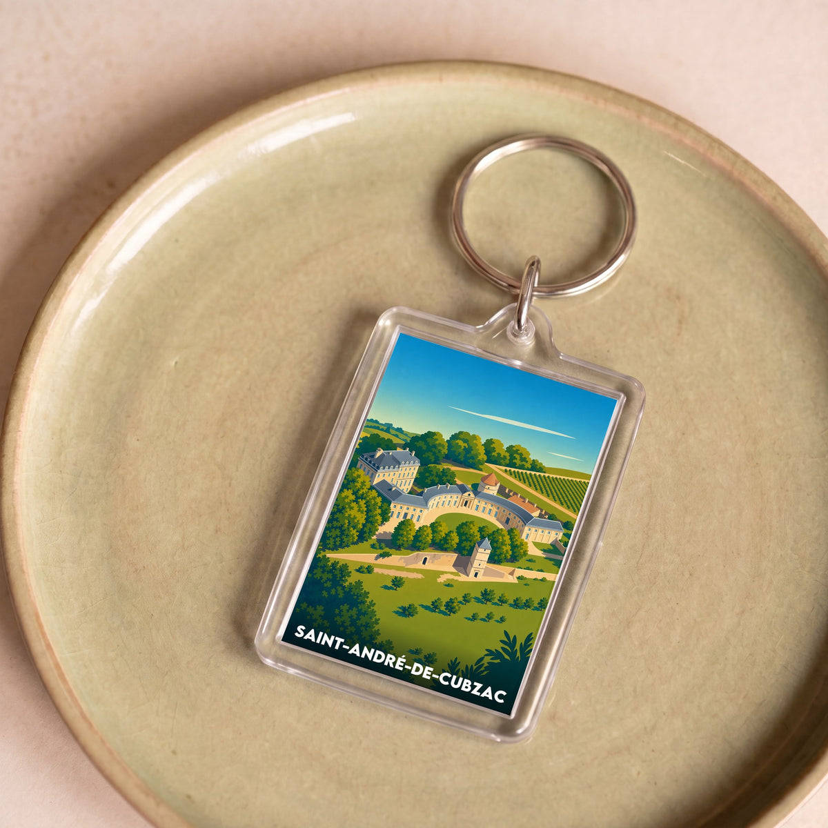 Porte-clés souvenir de la ville de Saint-André-de-Cubzac avec une illustration stylisée.