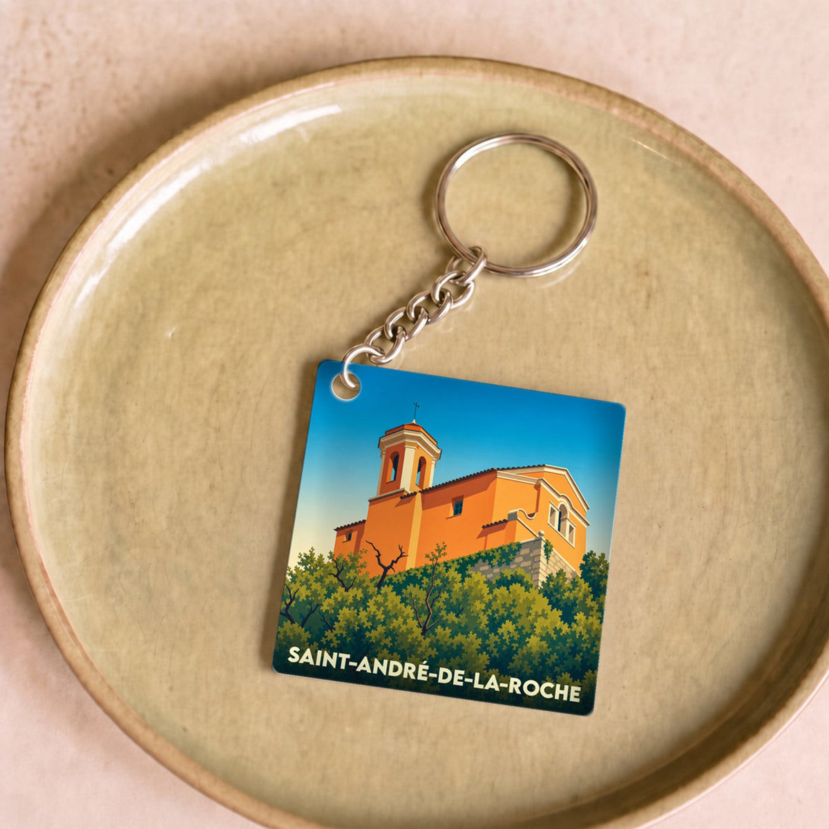 Porte-clés souvenir de la ville de Saint-André-de-la-Roche avec une illustration stylisée.
