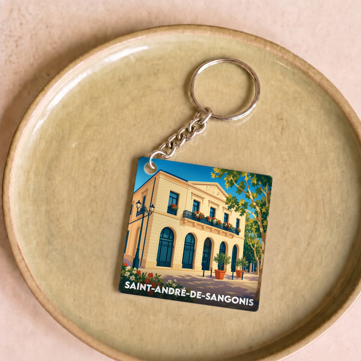 Porte-clés souvenir de la ville de Saint-André-de-Sangonis avec une illustration stylisée.
