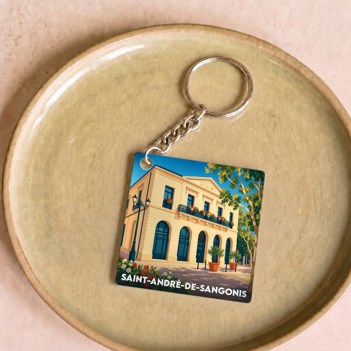 Porte-clés souvenir de la ville de Saint-André-de-Sangonis avec une illustration stylisée.