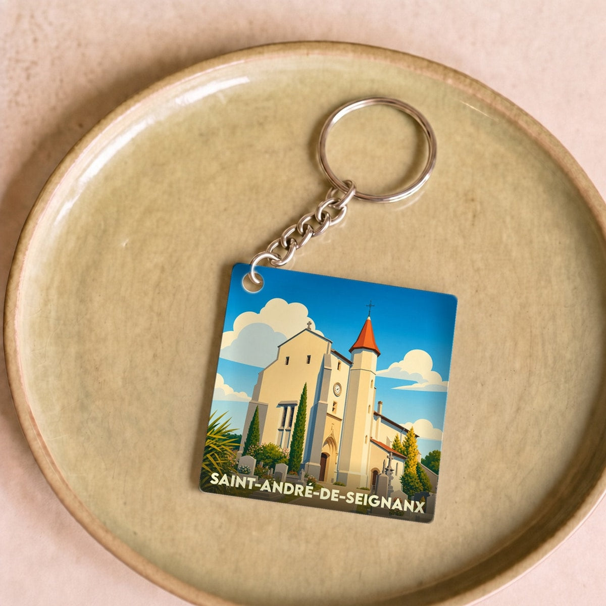 Porte-clés souvenir de la ville de Saint-André-de-Seignanx avec une illustration stylisée de son église.