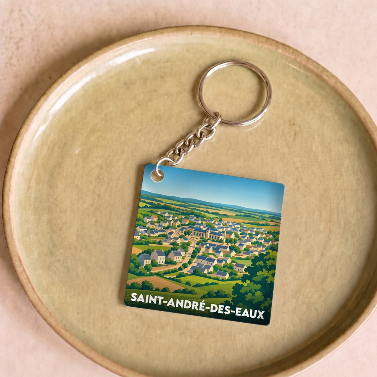 Porte-clés souvenir de la ville de Saint-André-des-Eaux avec une illustration stylisée.