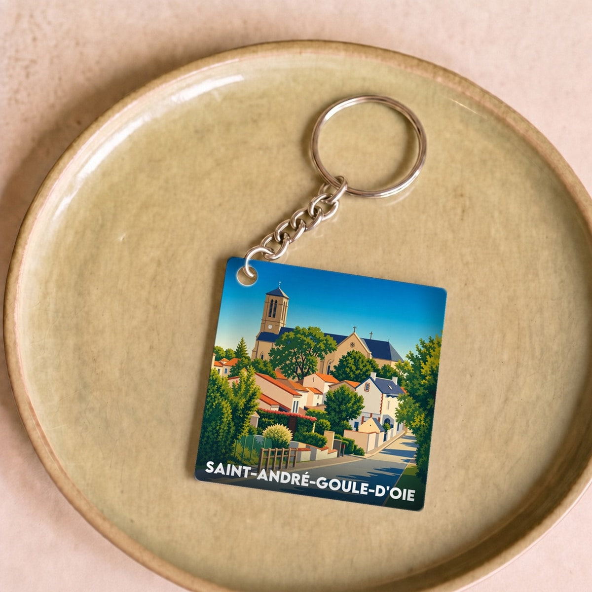 Porte-clés souvenir de la ville de Saint-André-Goule-d'Oie avec une illustration stylisée.