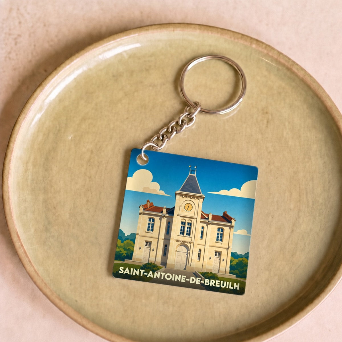Porte-clés souvenir de la ville de Saint-Antoine-de-Breuilh avec une illustration stylisée de sa mairie.