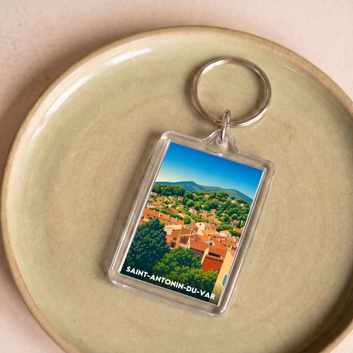 Porte-clés souvenir de la ville de Saint-Antonin-du-Var avec une illustration stylisée.
