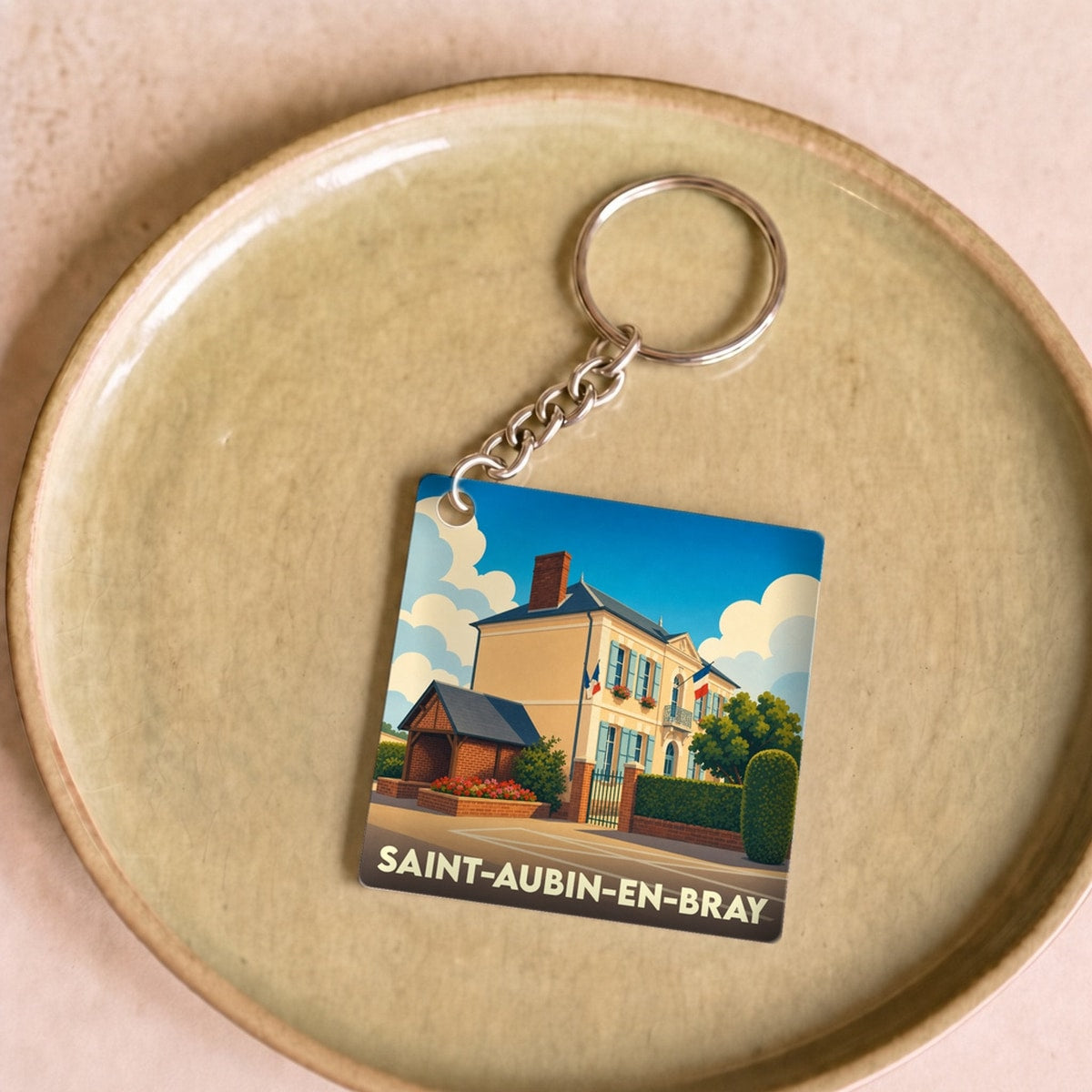 Porte-clés souvenir de la ville de Saint-Aubin-en-Bray avec une illustration stylisée.