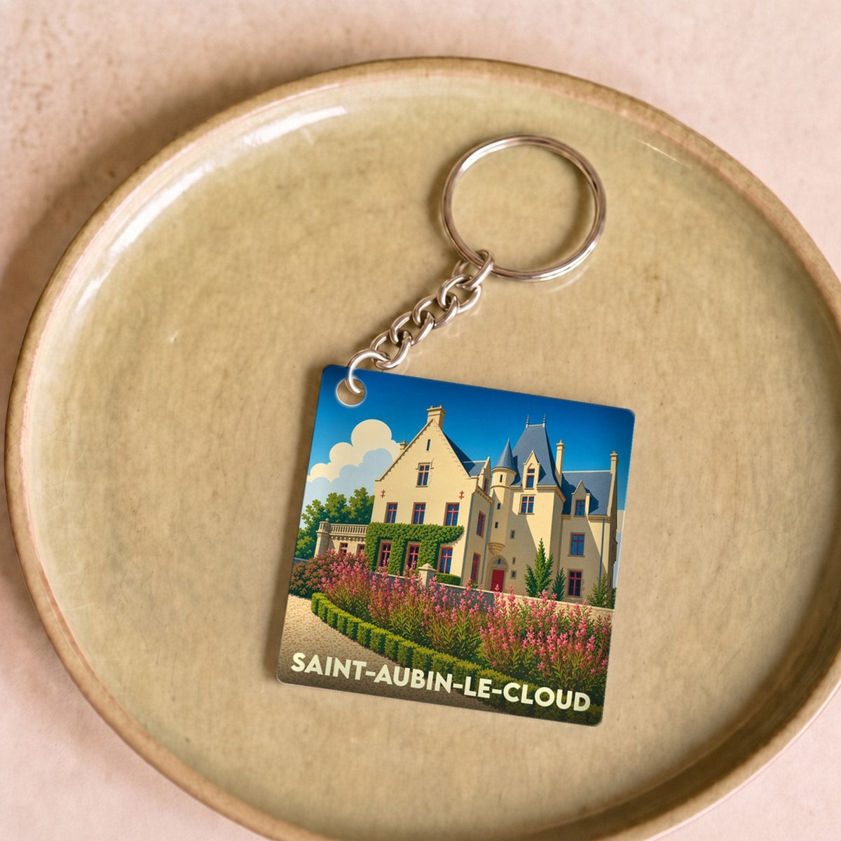 Porte-clés souvenir de la ville de Saint-Aubin-le-Cloud avec une illustration stylisée de château.