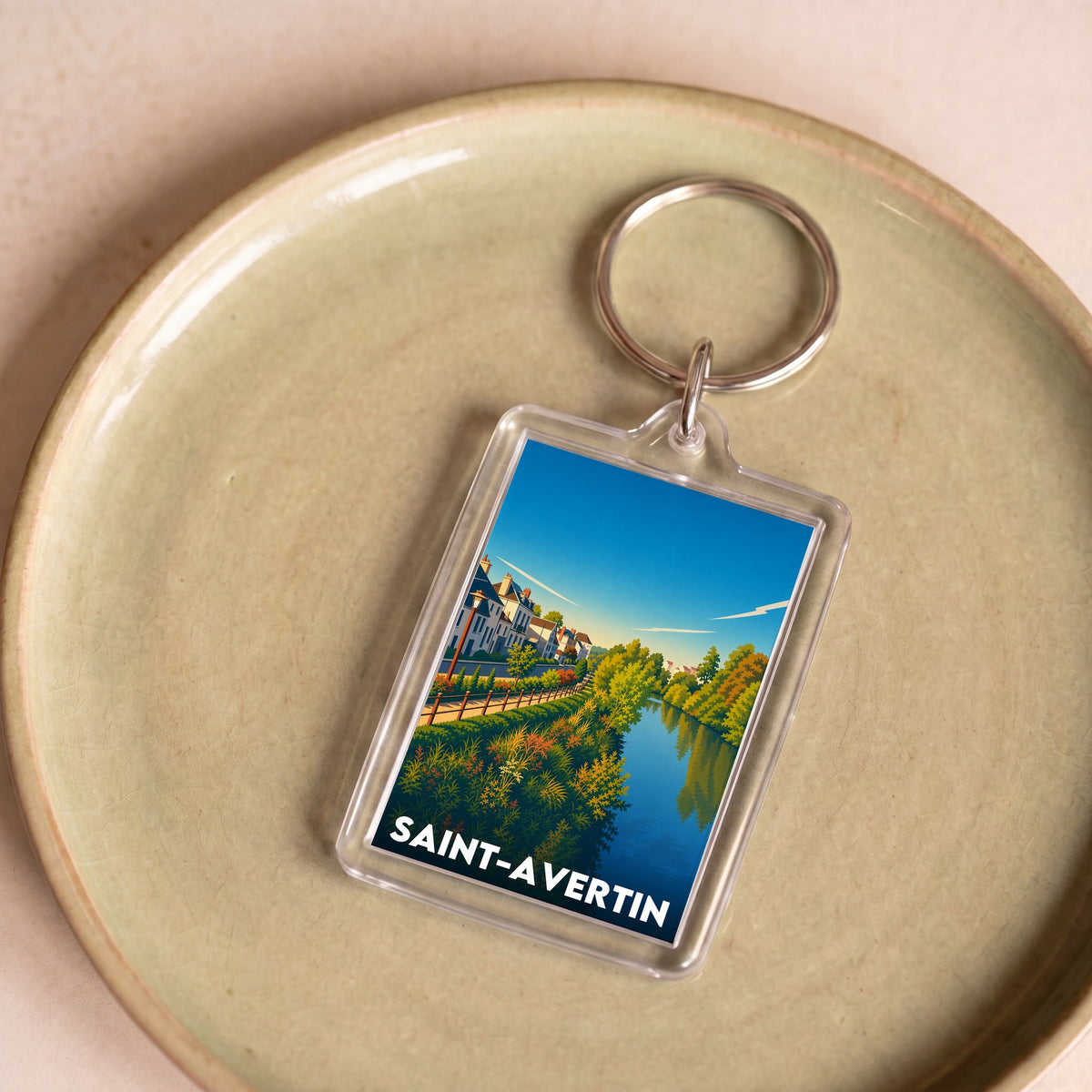 Porte-clés souvenir de la ville de Saint-Avertin avec une illustration de paysage stylisée.