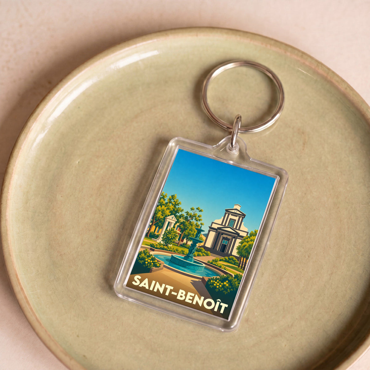 Porte-clés souvenir de la ville de Saint-Benoît avec une illustration stylisée.